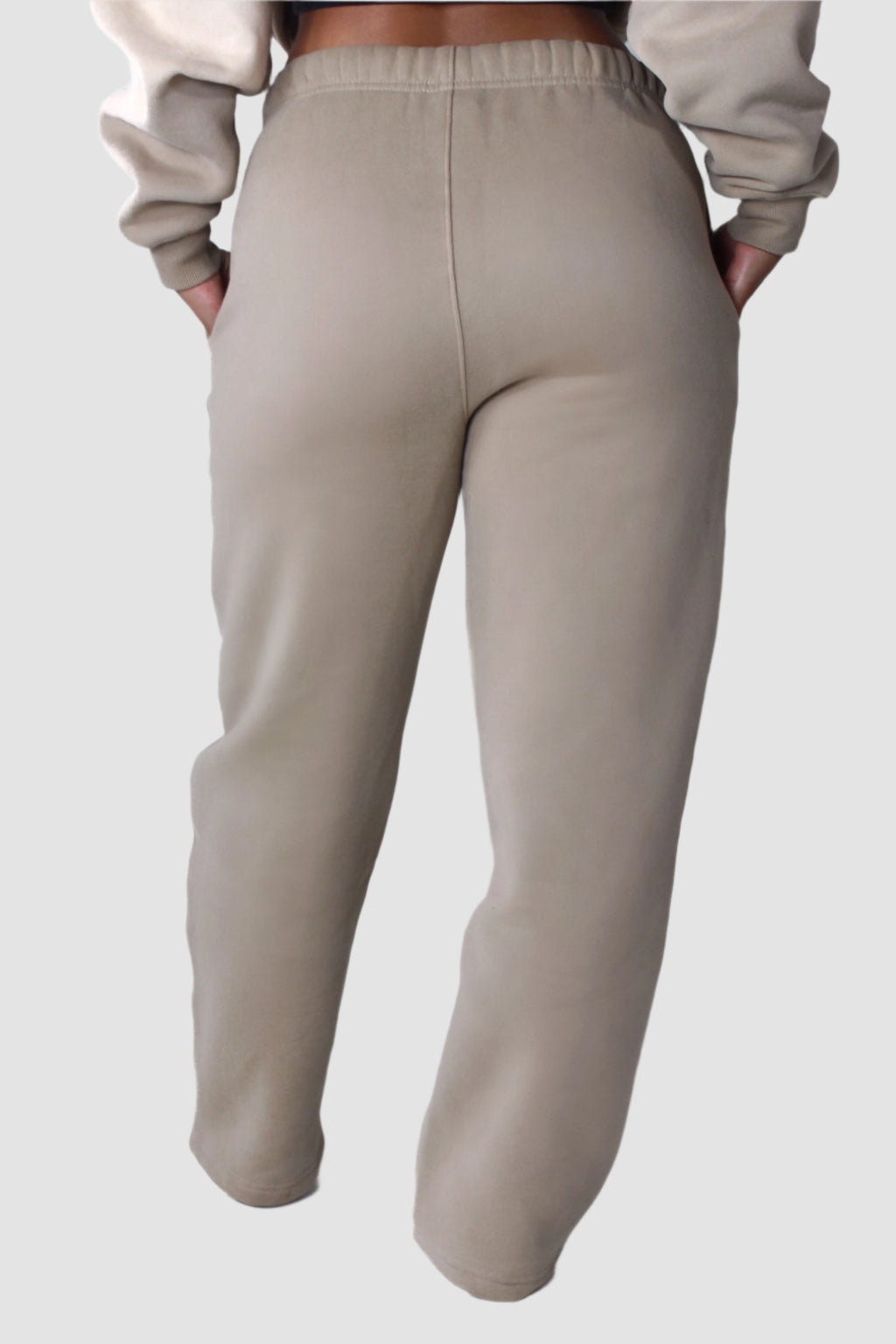 Back view of beige Aivvia Athletics fleece sweatpants, women’s athletic joggers for cozy and sporty style.