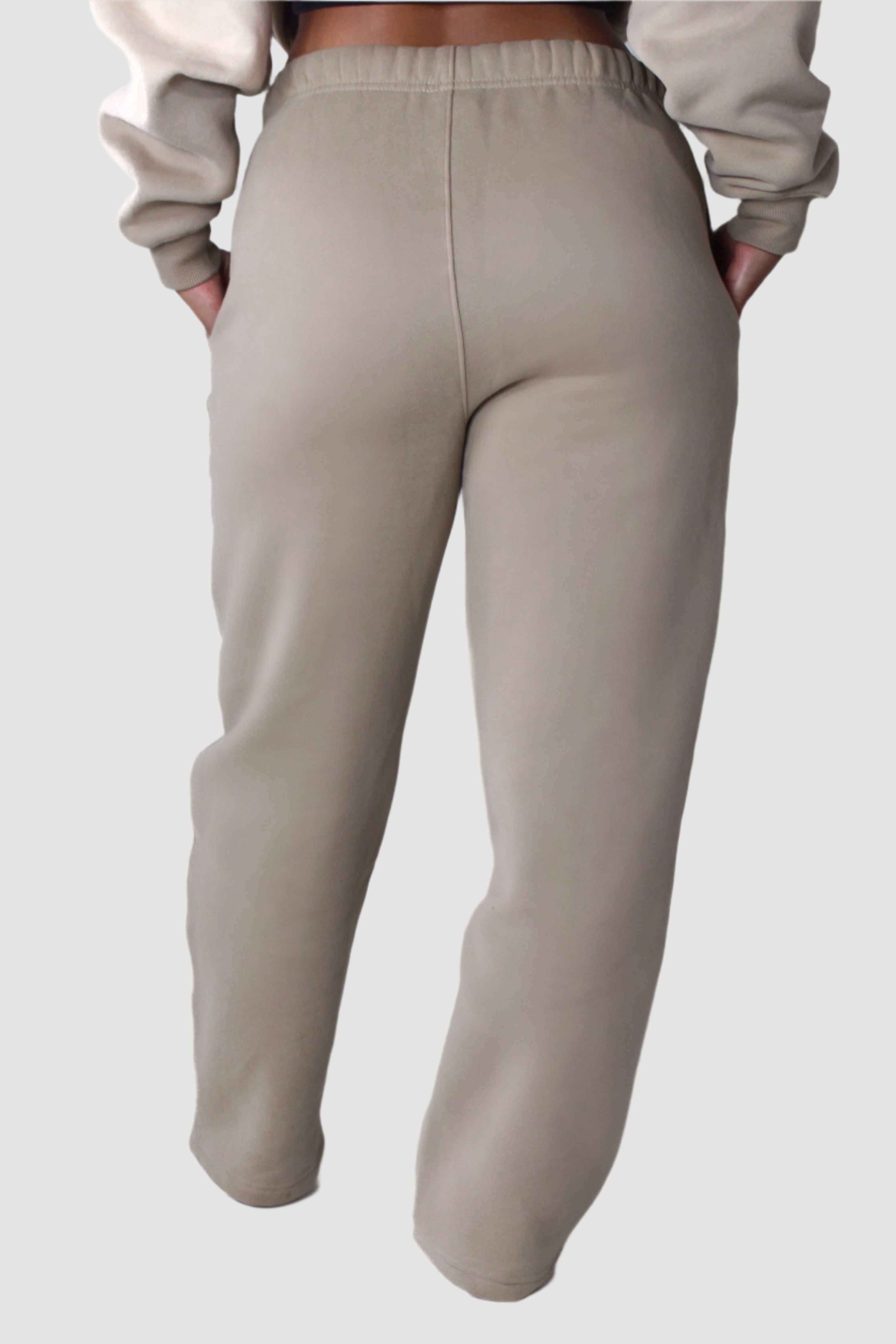 Back view of beige Aivvia Athletics fleece sweatpants, women’s athletic joggers for cozy and sporty style.