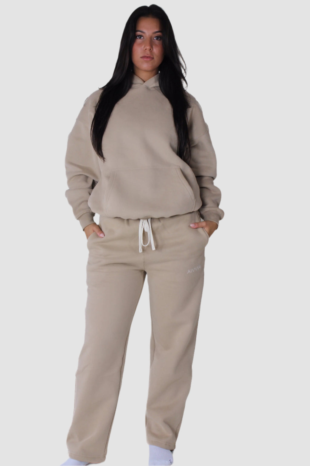 Beige Aivvia Athletics sweatpants set, women’s activewear joggers paired with matching hoodie.