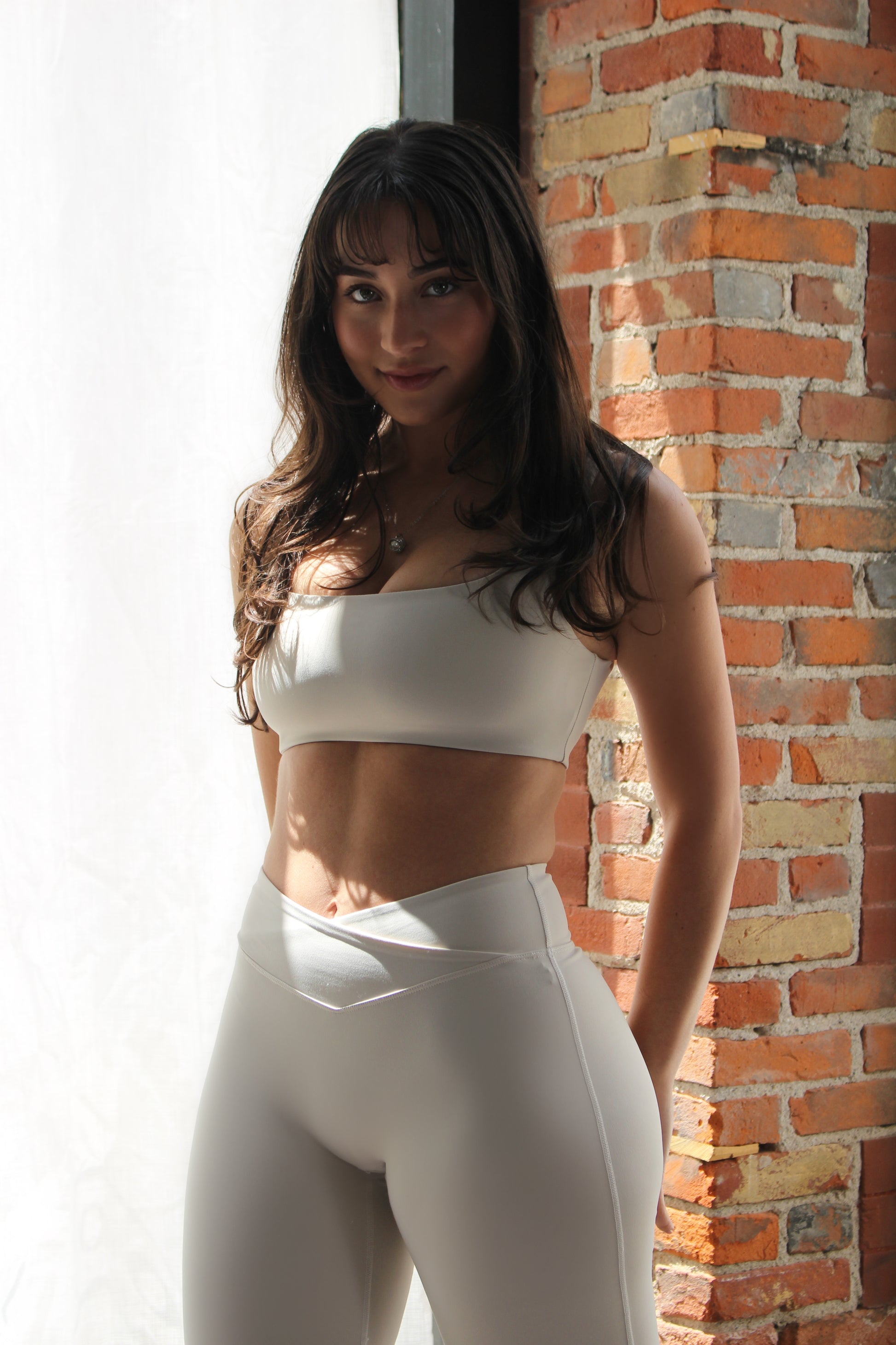 Aivvia Athletics seamless white sports bra with flattering fit and compression support for high-performance movement.