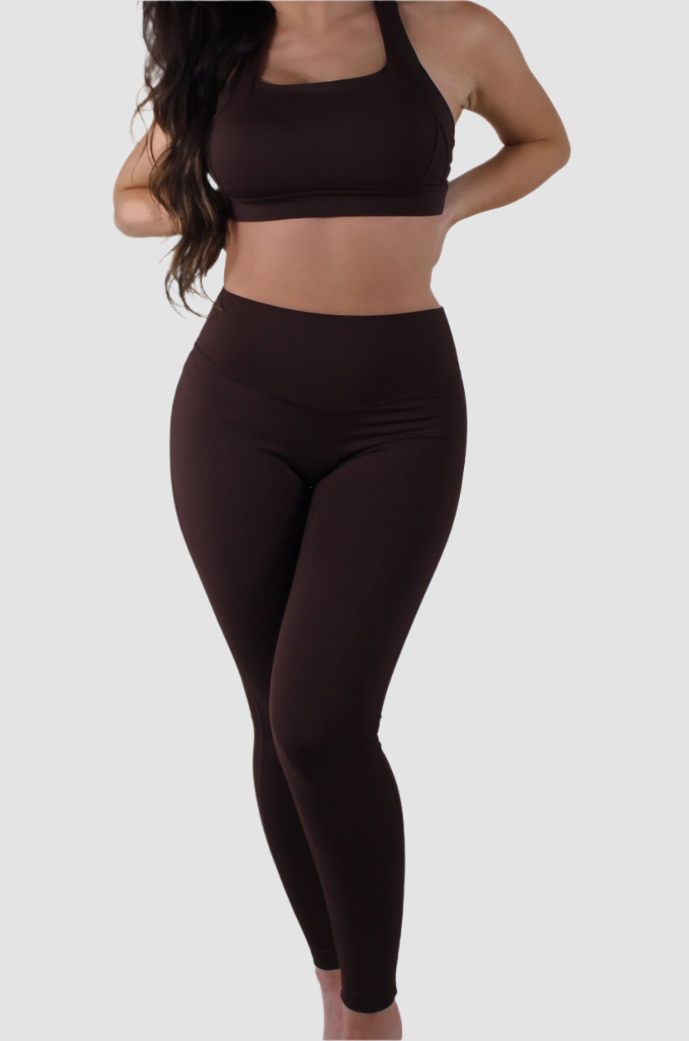 Angled front view of brown Aivvia Athletics high-waist leggings, sleek and form-fitting design.