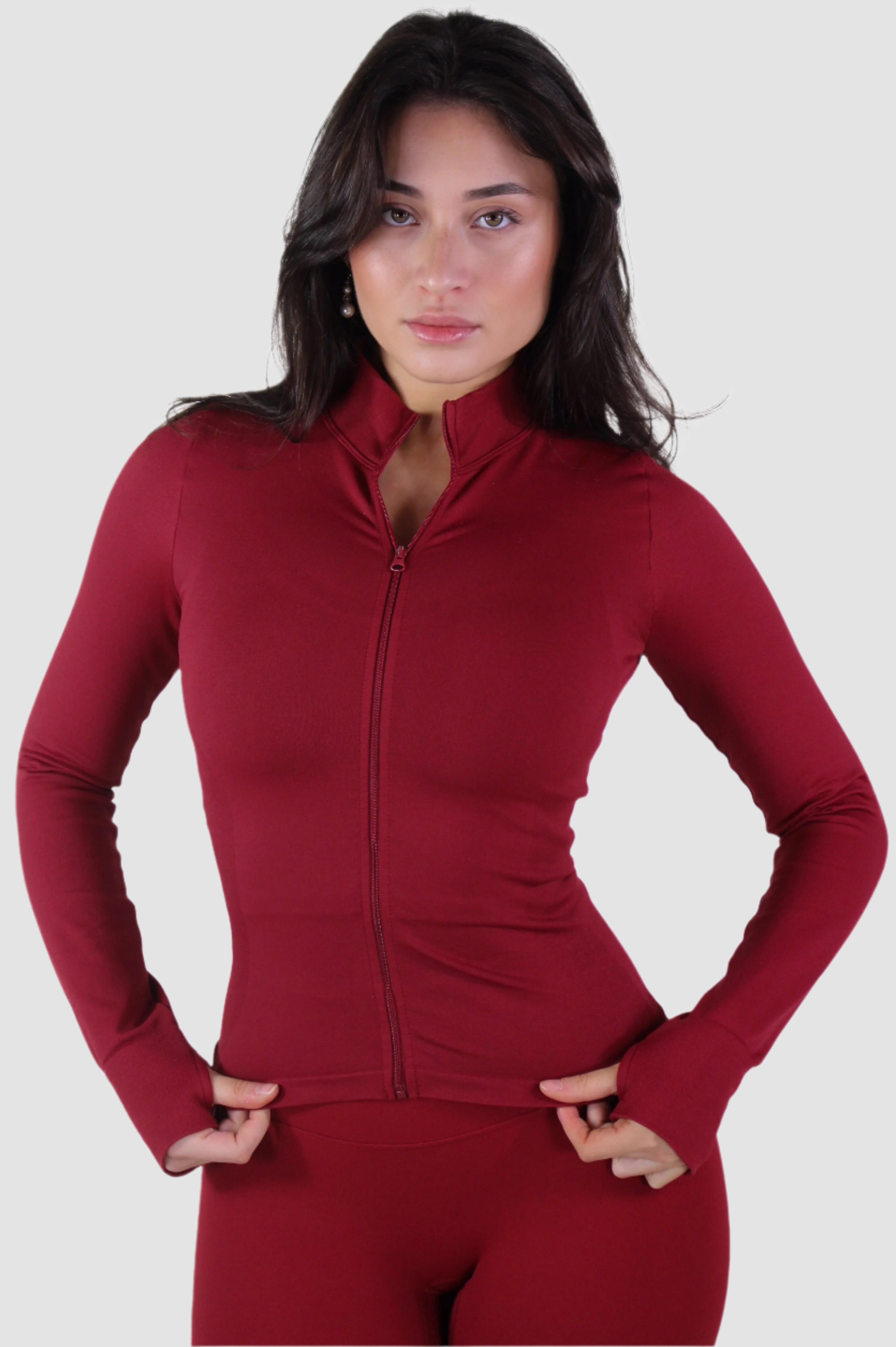 Front view of red Aivvia Athletics women’s zip-up athletic jacket, fitted design for activewear.