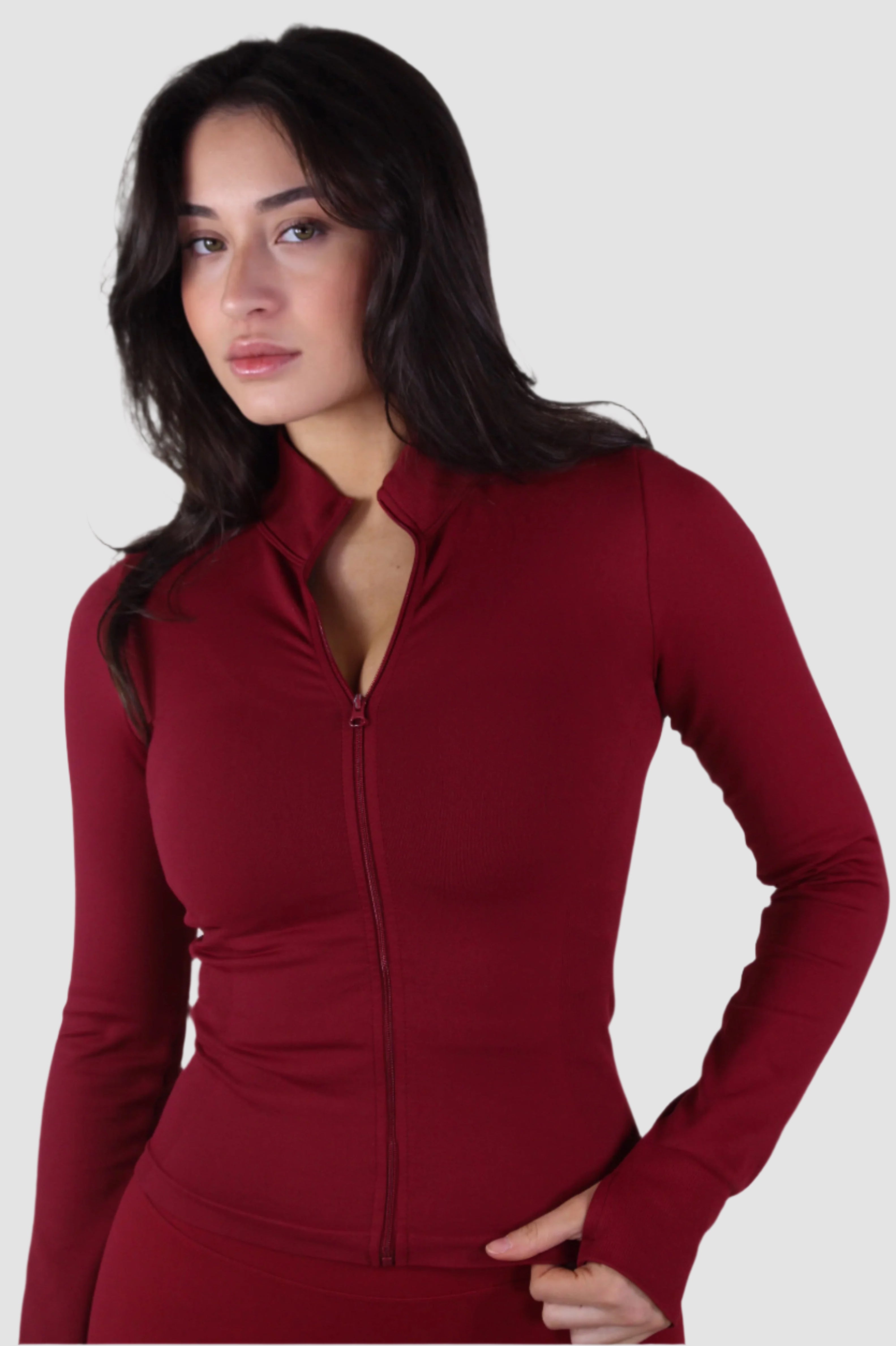 Angled front-side view of red Aivvia Athletics zip-up jacket, sleek women’s sportswear layer for training.