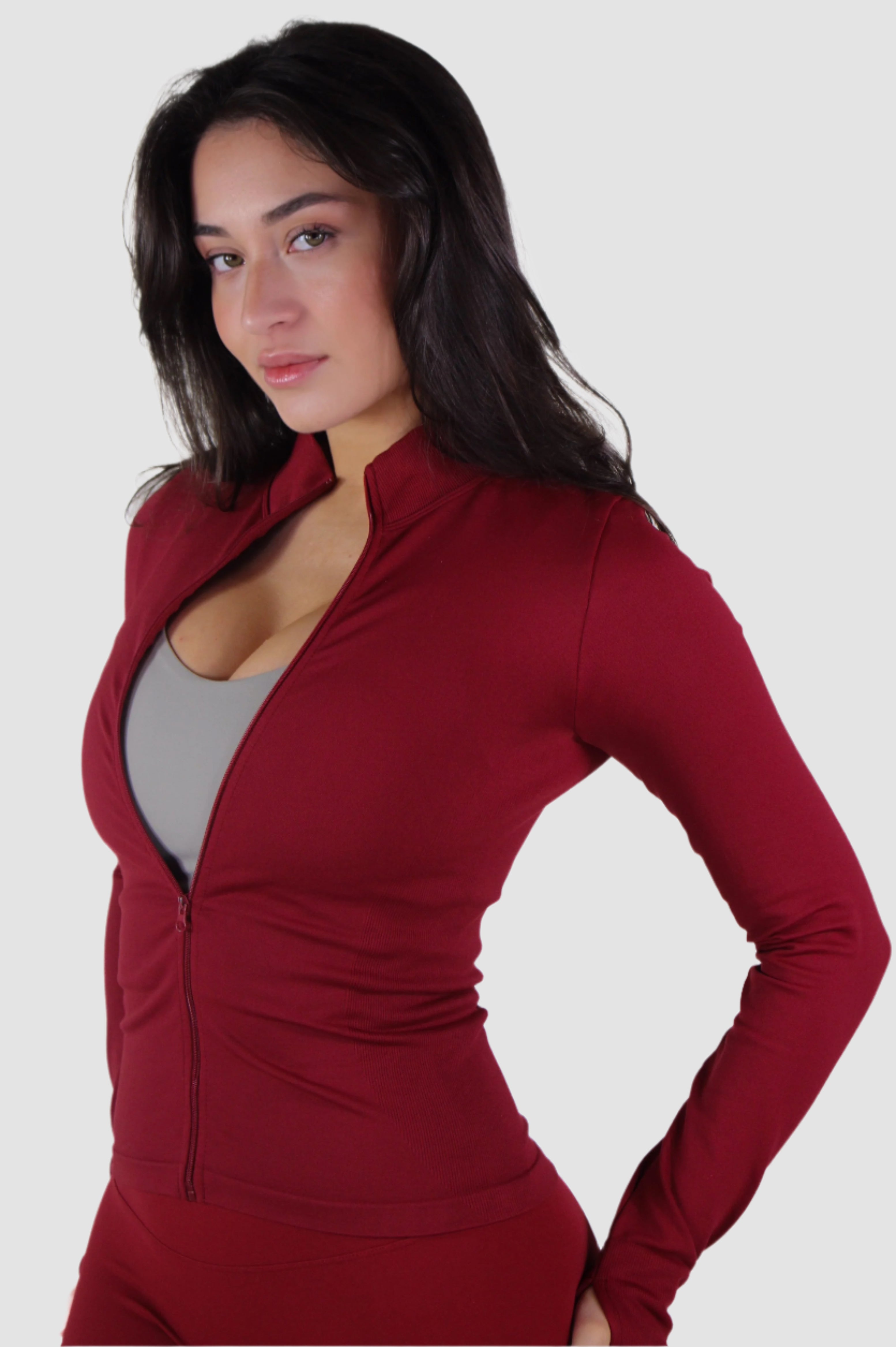 Side-back view of red Aivvia Athletics jacket, streamlined women’s activewear with zip closure.