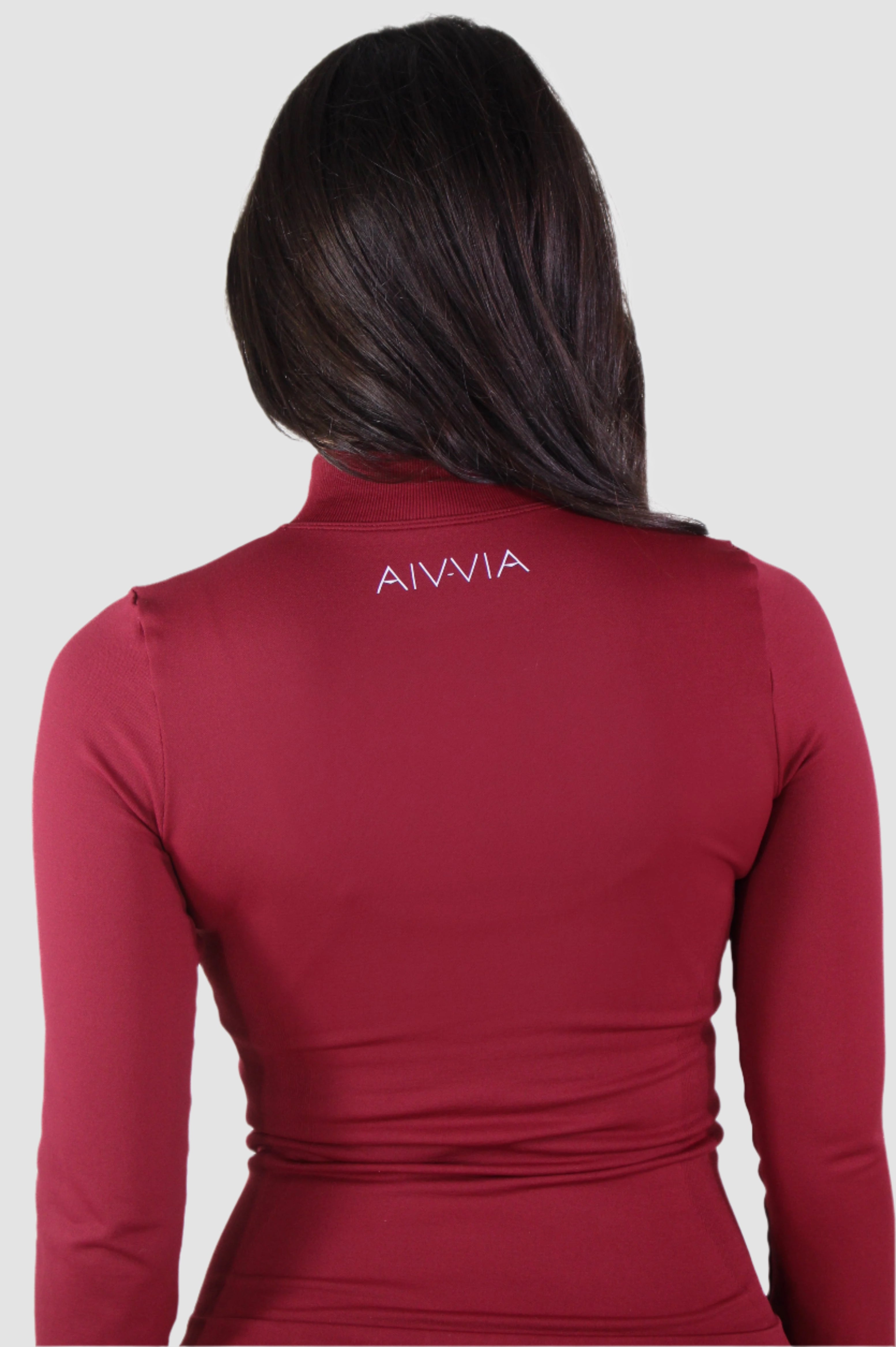 Back view of red Aivvia Athletics zip-up jacket with logo detail, performance athleticwear.