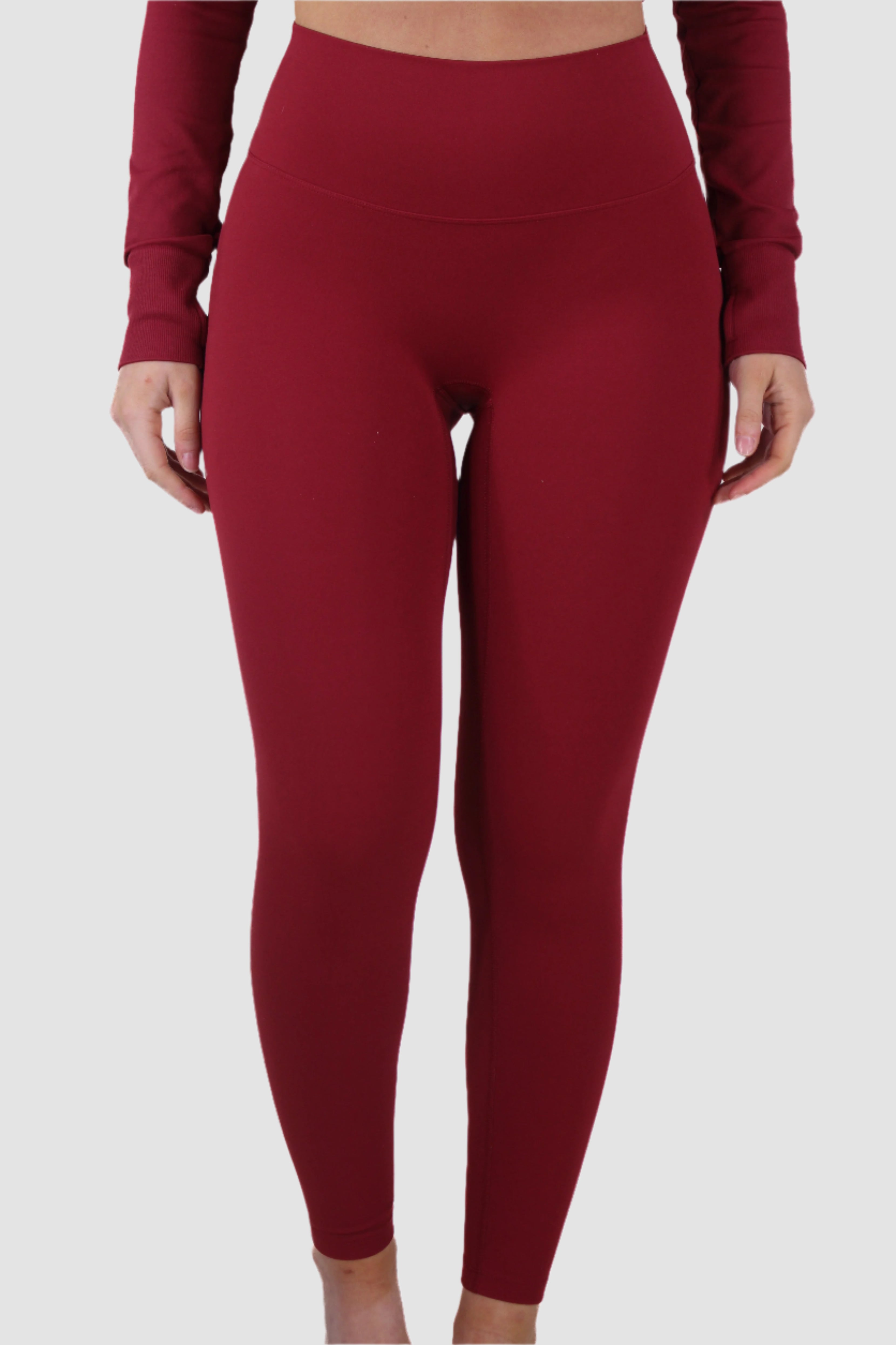 Front view of red Aivvia Athletics women’s leggings, high-waisted design with sleek performance fit.