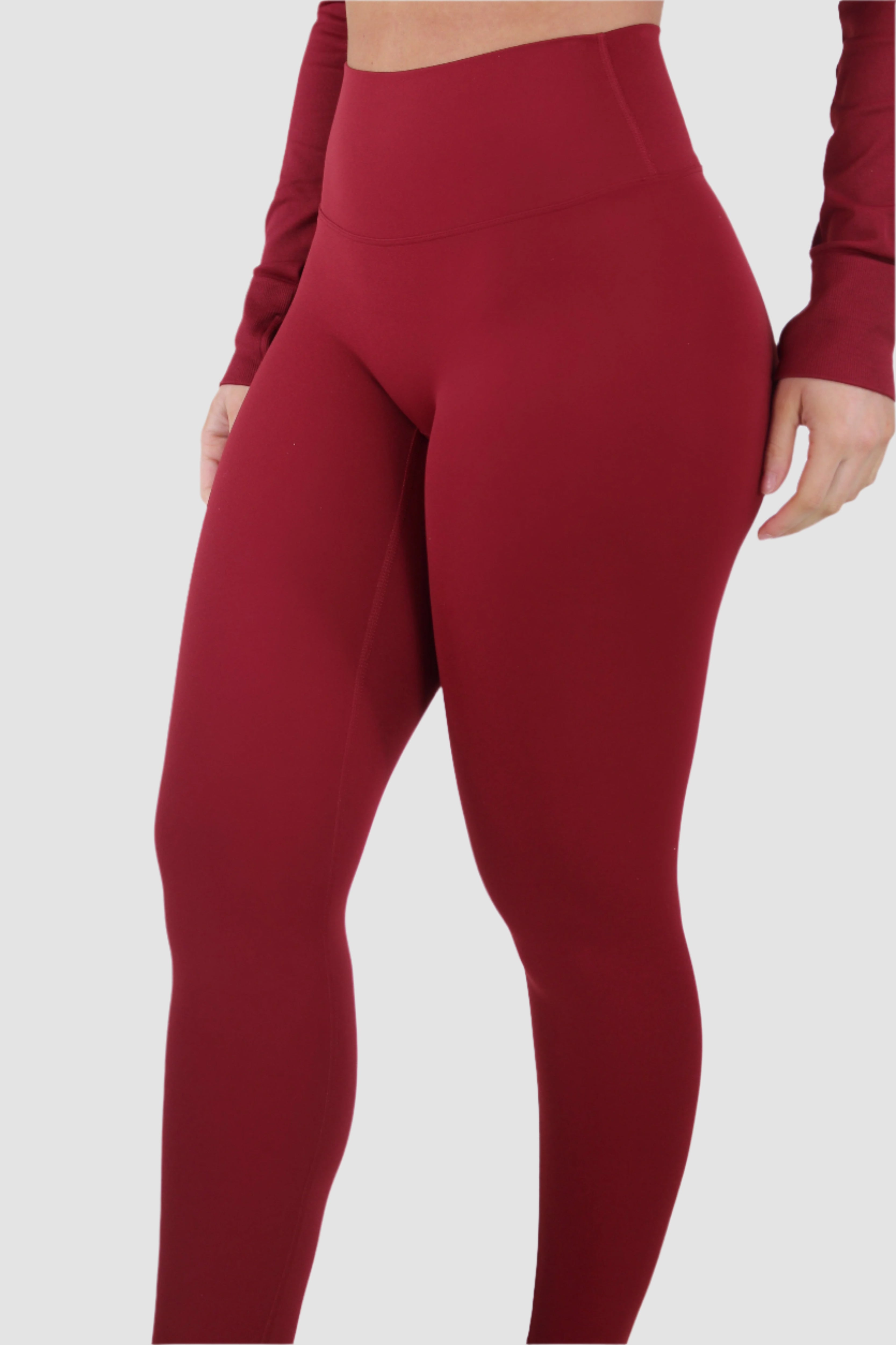 Side view of red Aivvia Athletics leggings, sculpting athleticwear with second-skin comfort.

