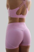 Back view of light pink Aivvia Athletics sports bra with heart-shaped cutout and seamless high-rise contour shorts.